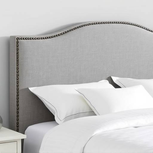 Upholstered headboard with nailhead trim and matching side rails in a gray linen fabric